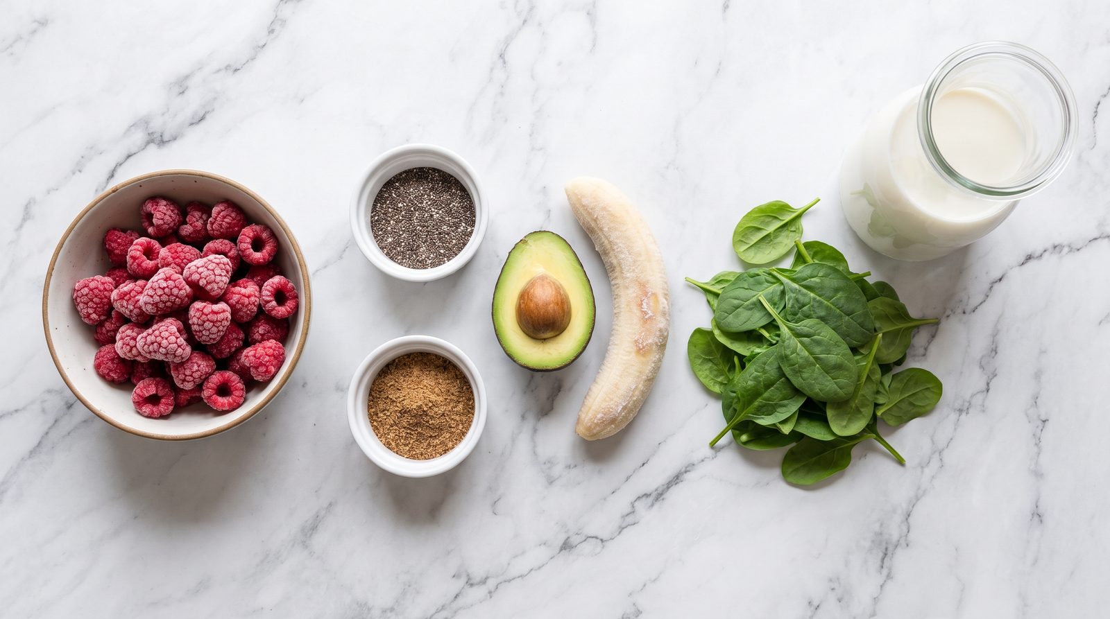 Ingredients for a high fiber smoothie: frozen raspberries, chia seeds, ground flaxseed, avocado, spinach and banana